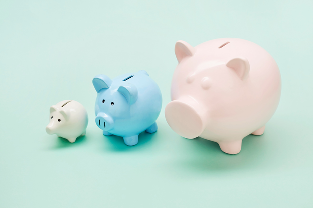 3 piggy banks (cream, blue, pink) on a light green background